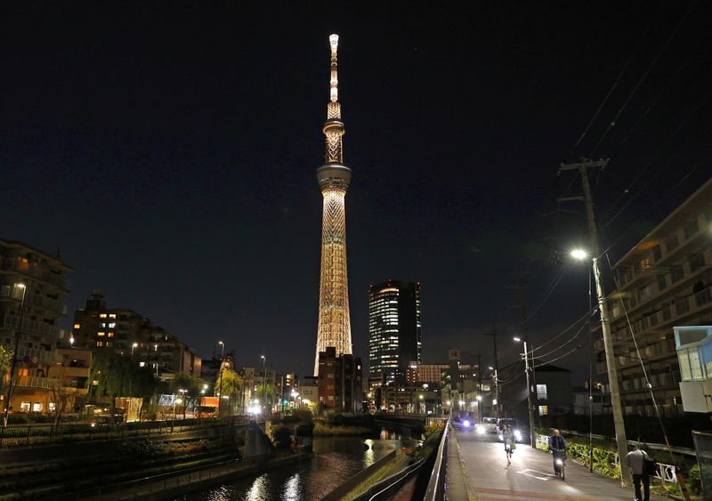 The Tokyo Skytree is illuminated with the color of the