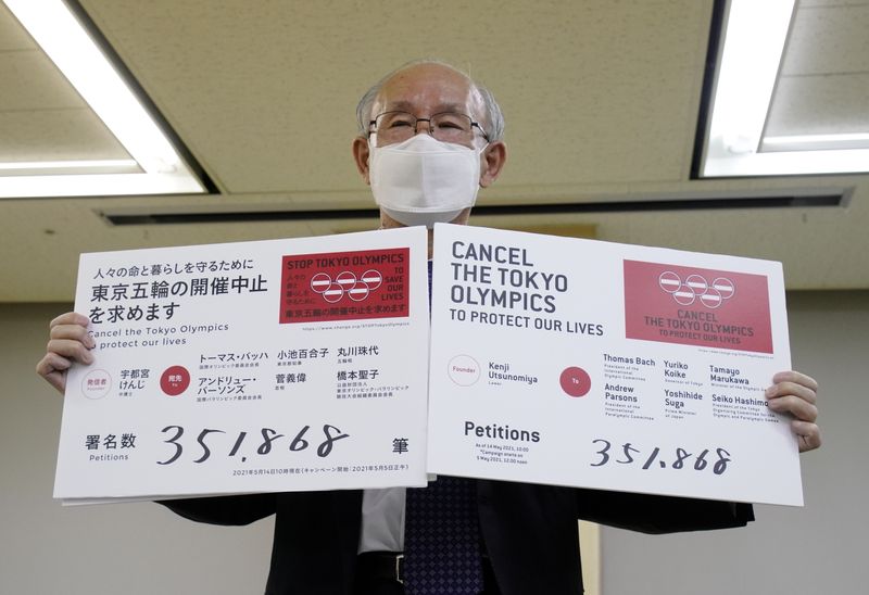 Lawyer Kenji Utsunomiya shows off placards during a news conference