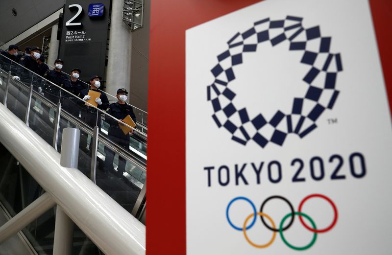 Police officers conduct a security sweep of the Tokyo Olympic