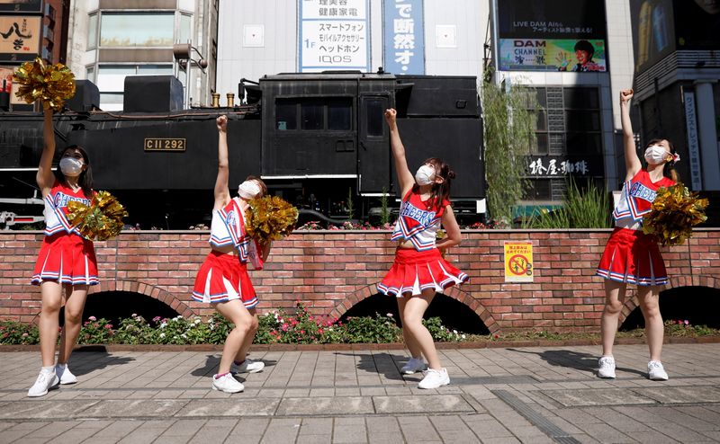 Cheerleaders perform at Shimbashi Station one day before Tokyo 2020