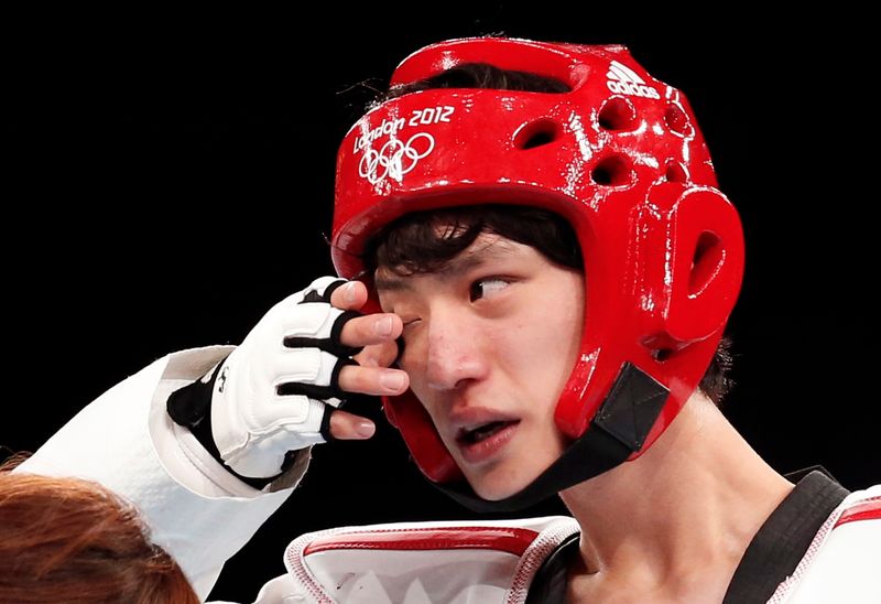 South Korea’s Lee Dae-hoon bleeds during his men’s -58kg gold