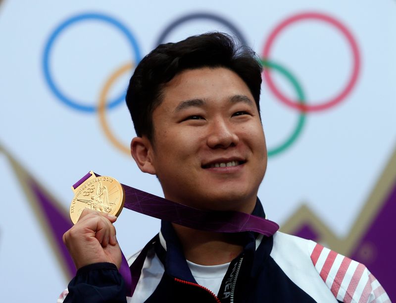 South Korea’s Jin Jong-oh poses with his gold medal at