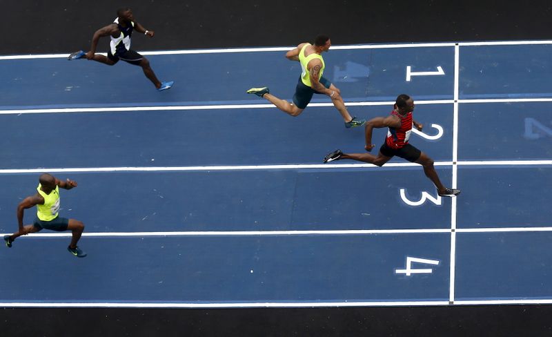 Jamaican Olympic gold medallist Bolt runs against Moreira of Brazil,