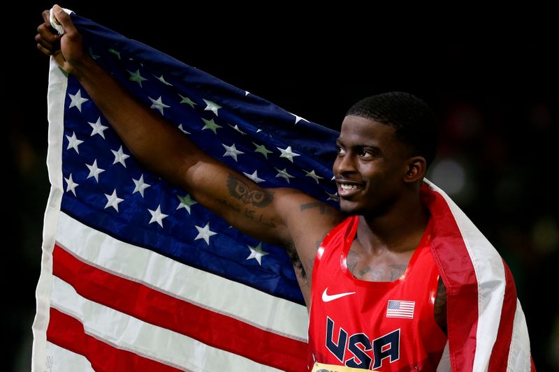 Bromell of the U.S. celebrates with an American flag after