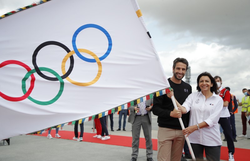 French Olympic medallists arrive with the Olympic flag in Paris