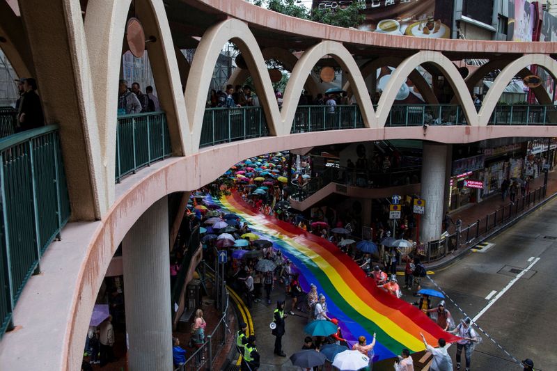 FILE PHOTO: Participants hold a giant rainbow flag during a