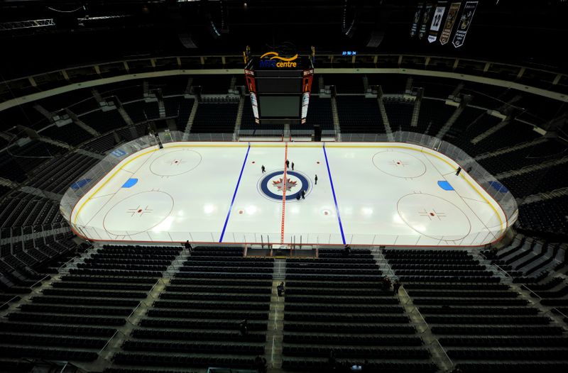 FILE PHOTO: Ice technicians at the MTS Centre install the