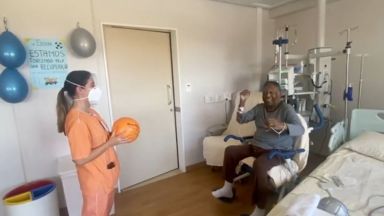 Brazilian soccer legend Pele tosses a ball with physical therapist
