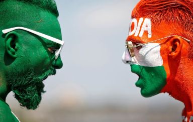 Cricket fans, with their faces painted in the Indian and
