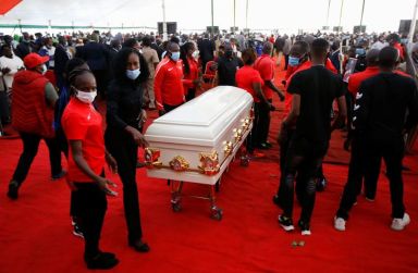 Kenyan athletes place the coffin of long-distance runner Agnes Tirop