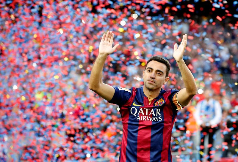 FILE PHOTO: Barcelona’s Xavi Hernandez waves to supporters after their