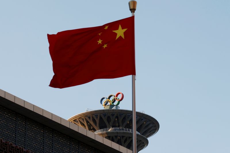 FILE PHOTO: Chinese flag flutters near the Olympic rings on