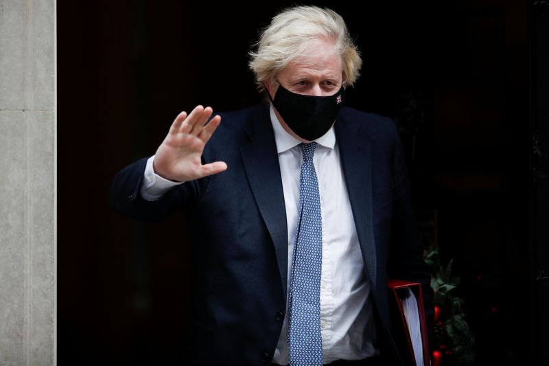 Britain’s PM Johnson walks outside Downing Street in London