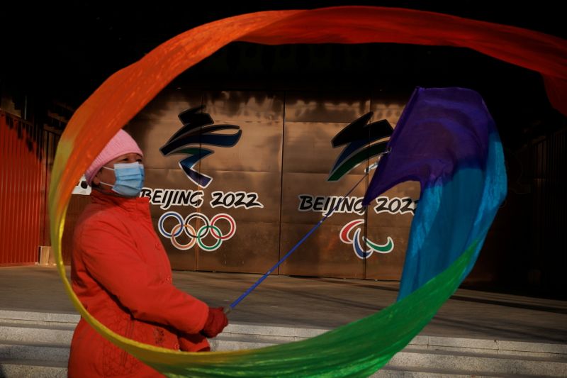 FILE PHOTO: A woman flies a ribbon near the logos