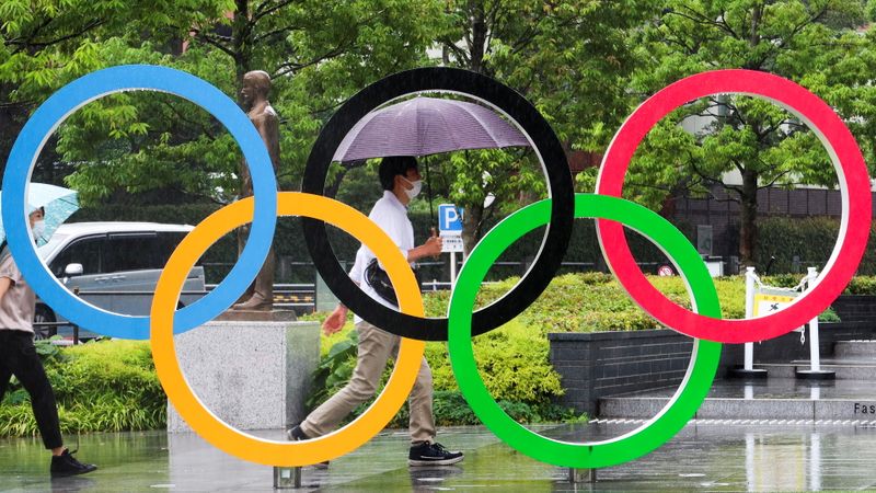 People walk outside the Japanese Olympic Committee (JOC) headquarters near