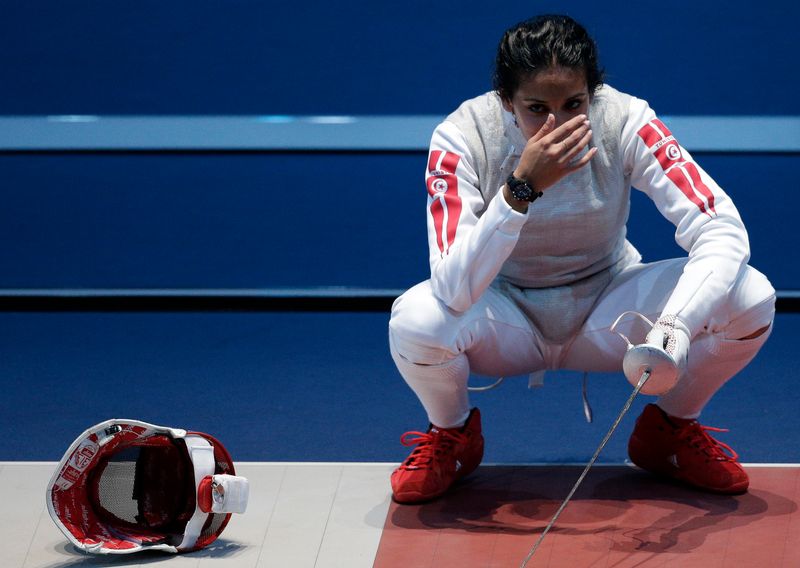 Tunisia’s Boubakri reacts after being defeated by Italy’s Vezzali during