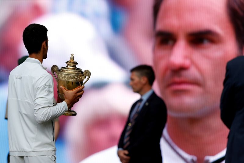 FILE PHOTO: Serbia’s Novak Djokovic holds the Wimbledon trophy after