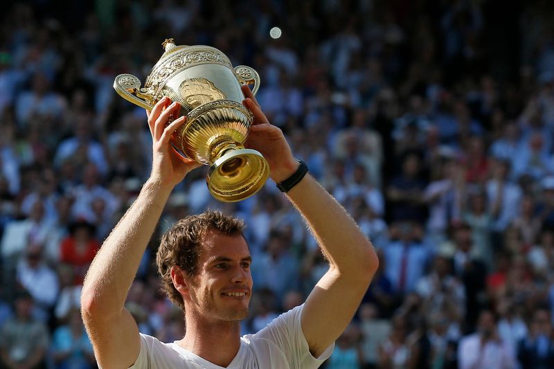 Murray of Britain holds the winners trophy after defeating Novak