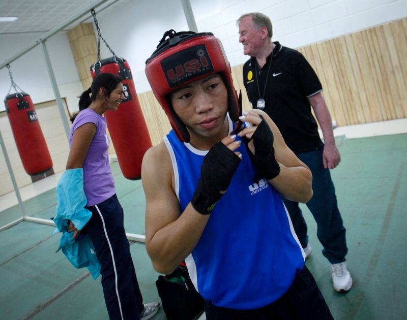 India’s boxer MC Mary Kom wears her head protection gear