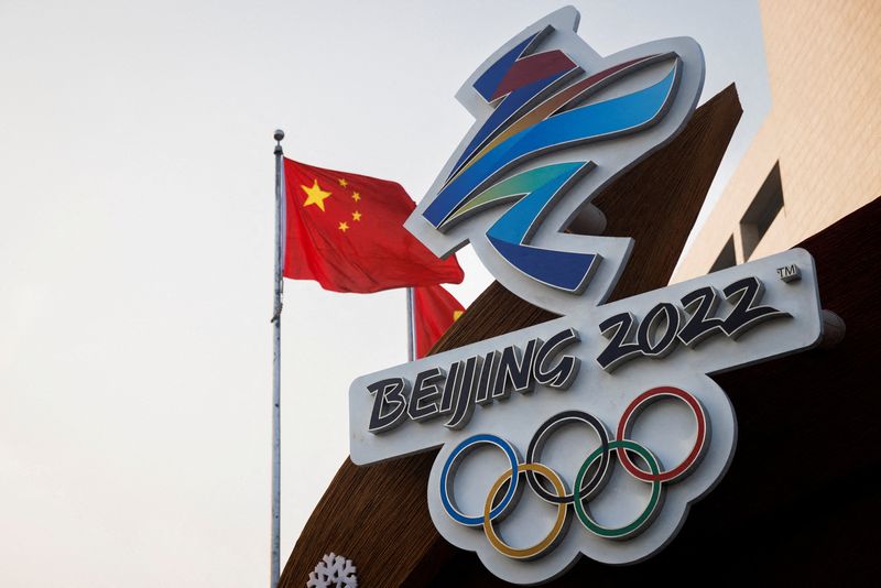 FILE PHOTO: The Chinese national flag flies behind the logo