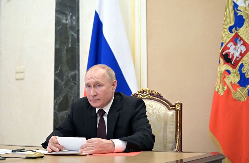 Russian President Vladimir Putin chairs a meeting with members of