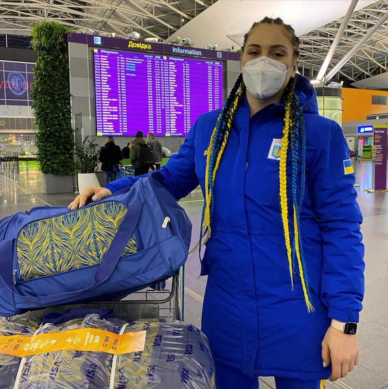 Ukrainian bobsledder, Lidiia Hunko, poses next to her luggage at