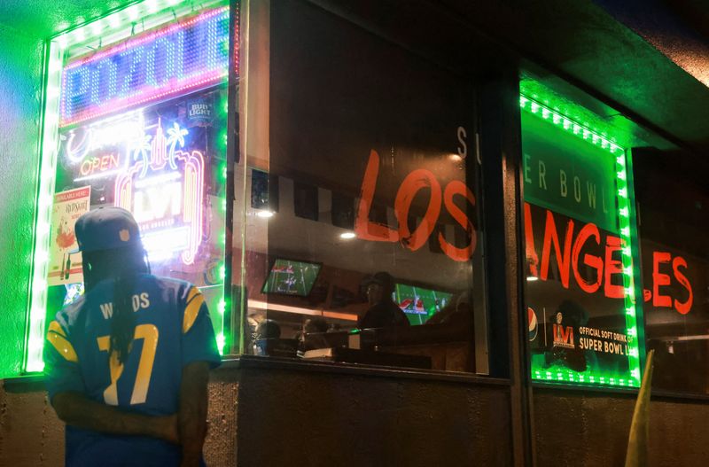 A Los Angeles Rams supporter watches the Super Bowl from