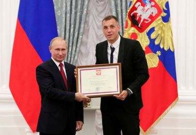 FILE PHOTO: Russia’s President Putin poses with Russia’s national soccer