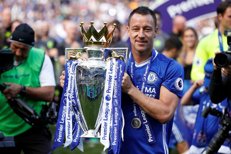 FILE PHOTO: Chelsea’s John Terry celebrates with the trophy after