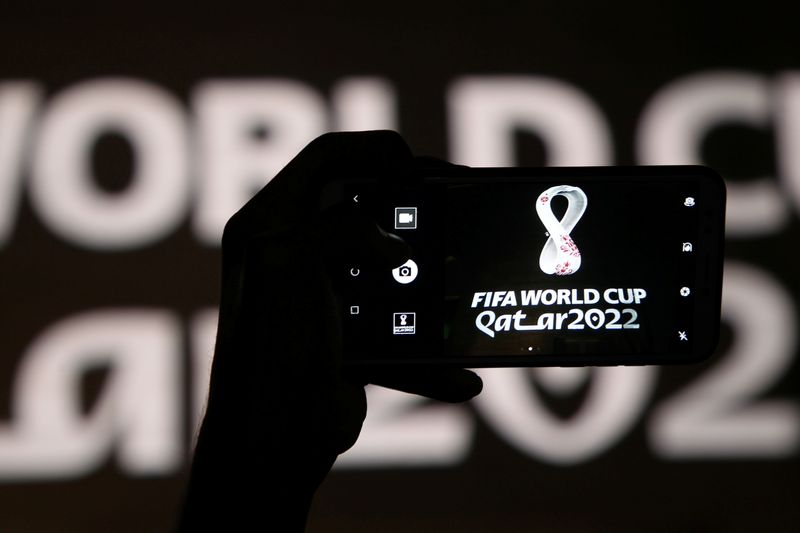 A man takes a picture of the tournament’s official logo