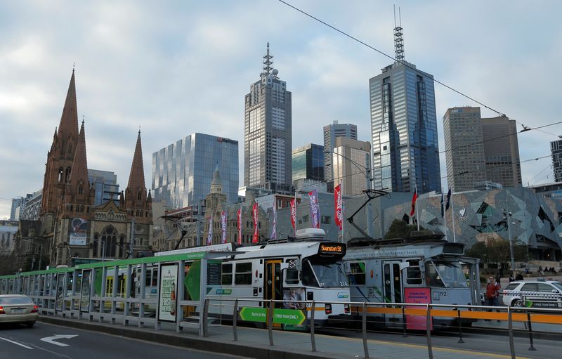 Trams pass by Melbourne’s city skyline in Australia’s second-largest city