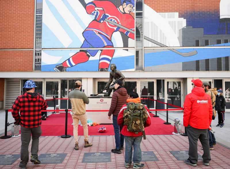 Fans pay respect in front of statue of Montreal Canadiens