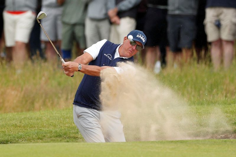 FILE PHOTO: Phil Mickelson plays out of a bunker during