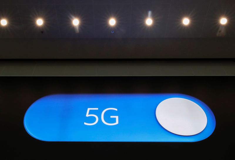 An advertising board shows a 5G logo at the International