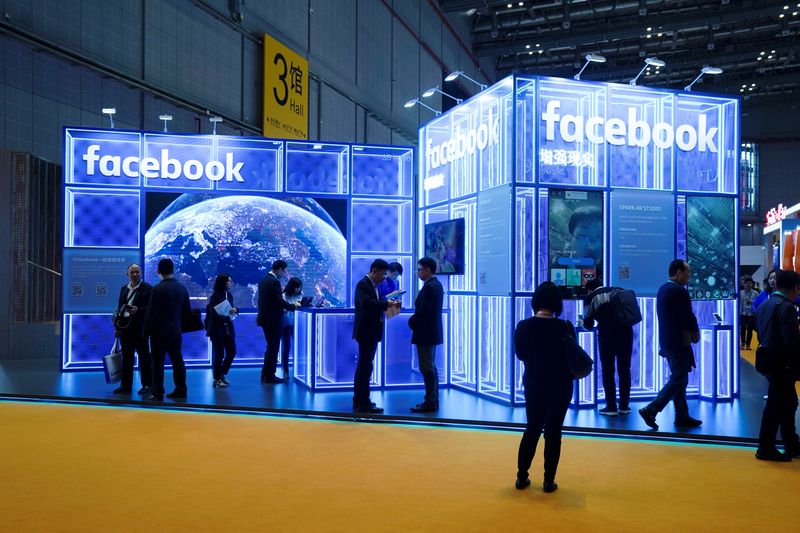 Facebook signs are seen during the China International Import Expo