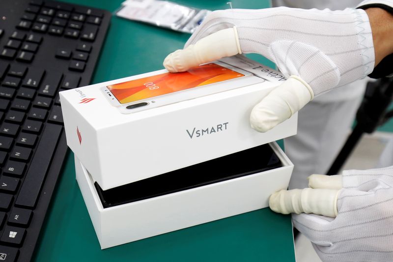 A manufacturer works at an assembly line of Vingroup’s Vsmart