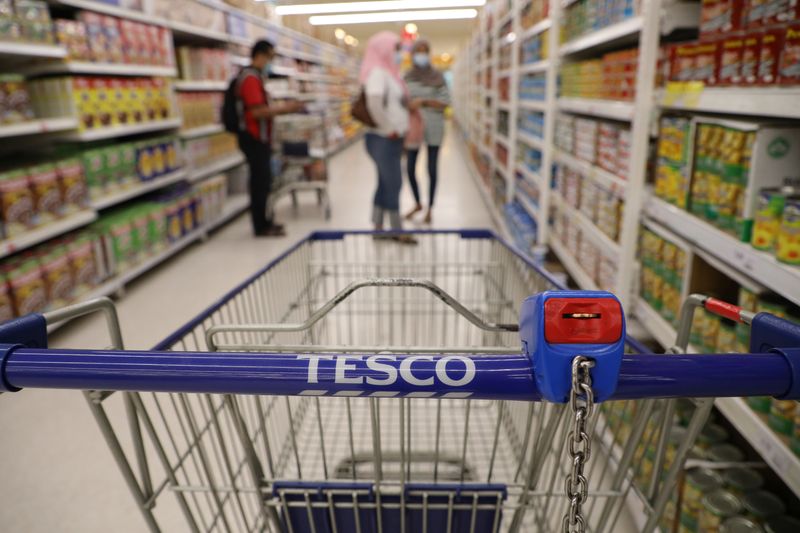 A shopping cart is pictured in a Tesco supermarket, amid