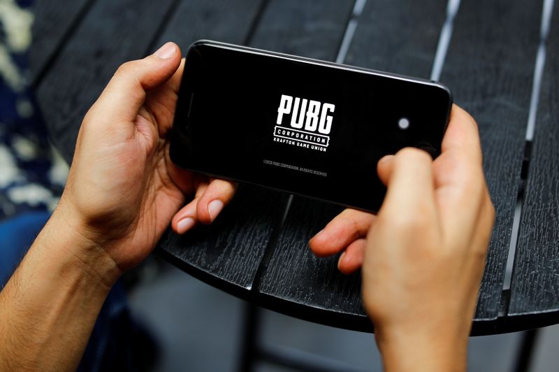 A boy plays Tencent Holdings’ PUBG videogame on his mobile