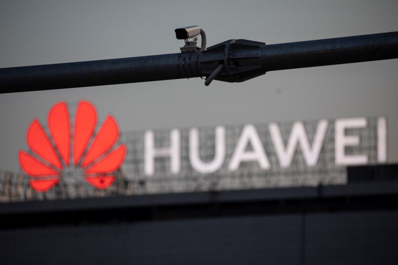 A surveillance camera is seen in front of a Huawei
