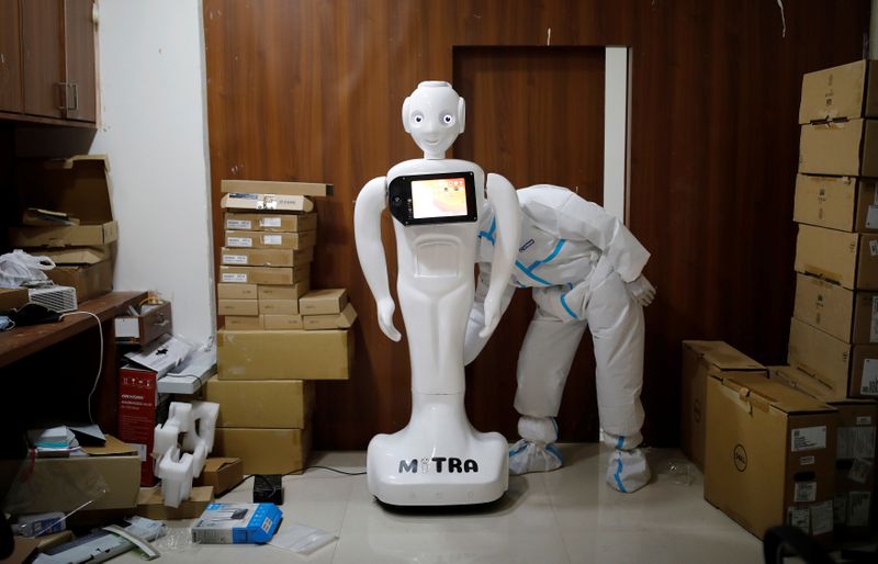 A medical worker puts robot named ‘Mitra’ , which is