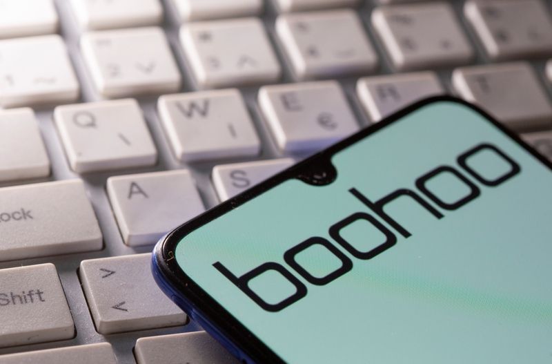 A smartphone with the Boohoo logo displayed is seen on