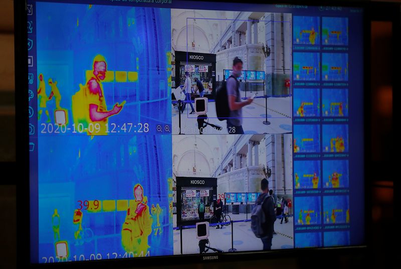 A commuter is seen through a thermal camera at Retiro
