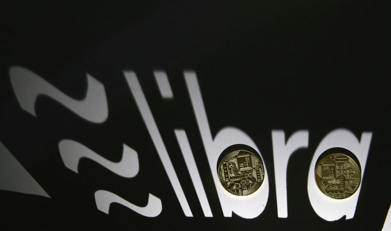 Shadow of a 3D-printed Facebook Libra cryptocurrency logo is seen