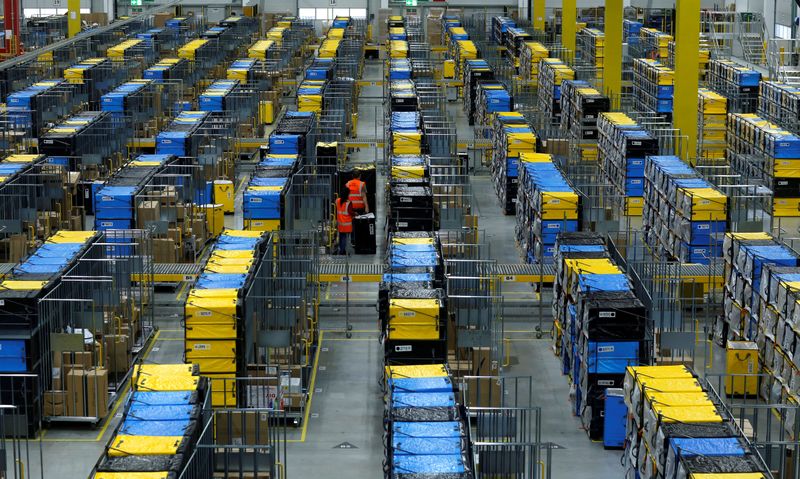 FILE PHOTO: Employees handle packages at an Amazon logistic center
