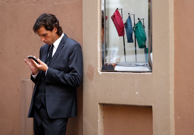 Man looks at his iPhone in Rome