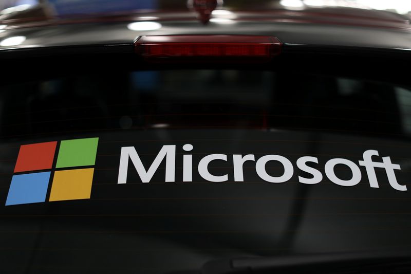 The Microsoft logo is shown on an electric car at