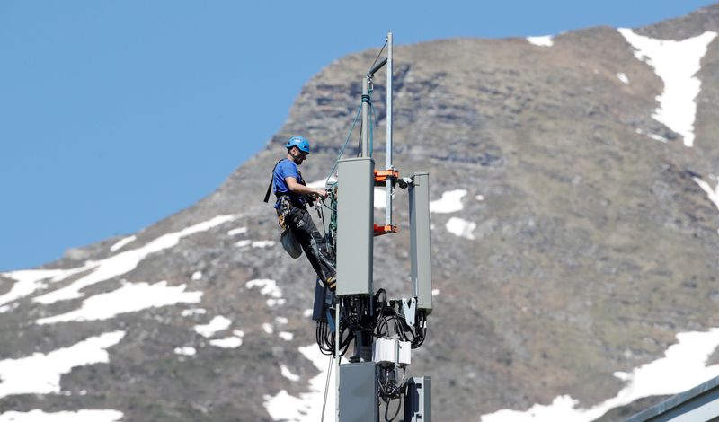 FILE PHOTO: A technician installs 5G antennas of Swiss telecom