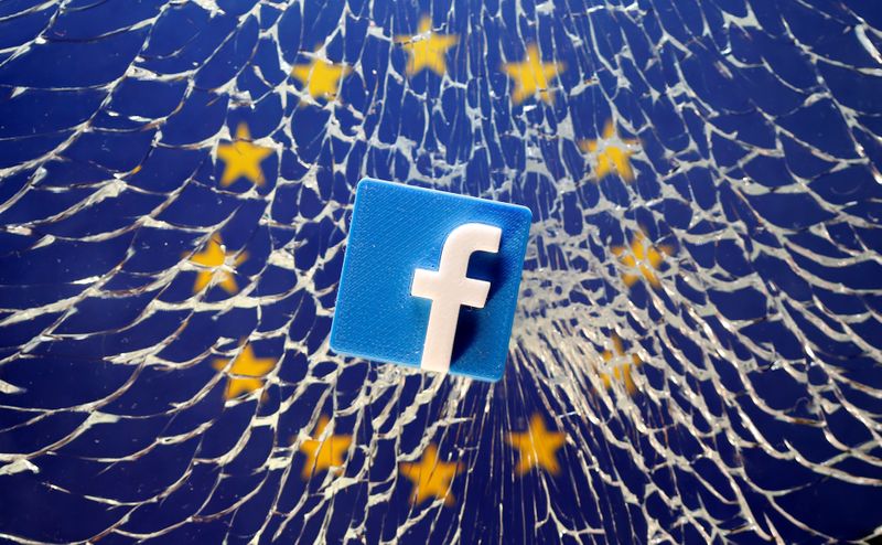 A 3D printed Facebook logo is placed on broken glass