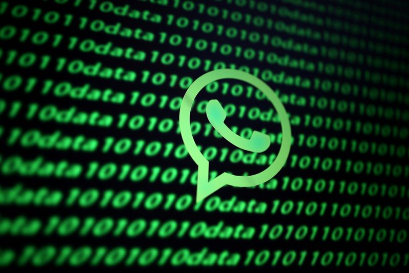 FILE PHOTO: The Whatsapp logo and binary cyber codes are