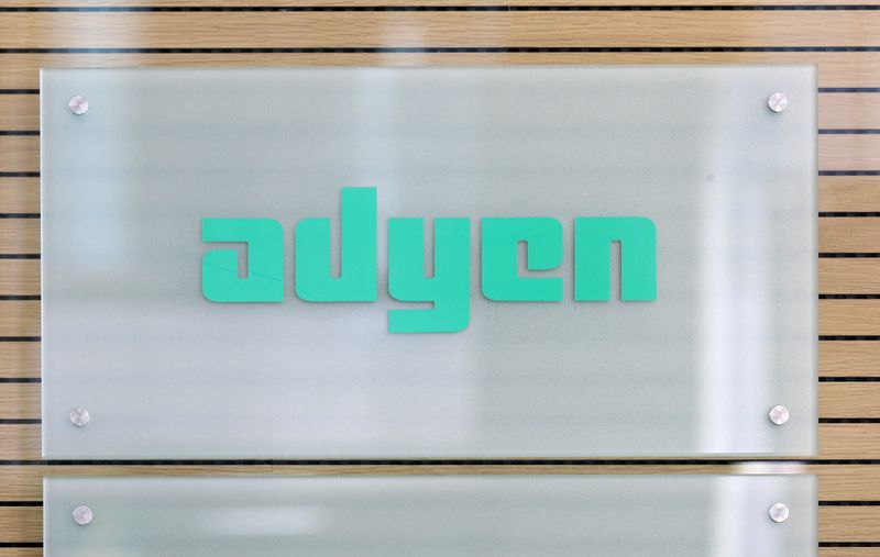 The Adyen logo is seen at the reception desk of